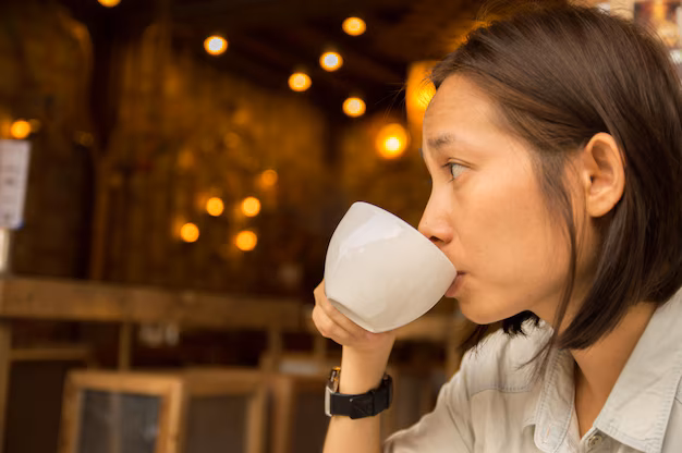asian woman drinking from coffee cup cafe 1048944 15360373