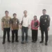 Photo of Andrew Joseph McLean with Immigration officers when he was about to be deported at Bali Airport.