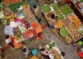 Buying and selling activities in Bali's traditional markets, with traders and buyers interacting among food commodities, reflect the dynamics of people's daily consumption.