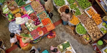 Buying and selling activities in Bali's traditional markets, with traders and buyers interacting among food commodities, reflect the dynamics of people's daily consumption.
