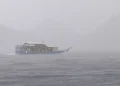 A phinisi ship sails amidst heavy rain in the waters off Labuan Bajo some time ago.