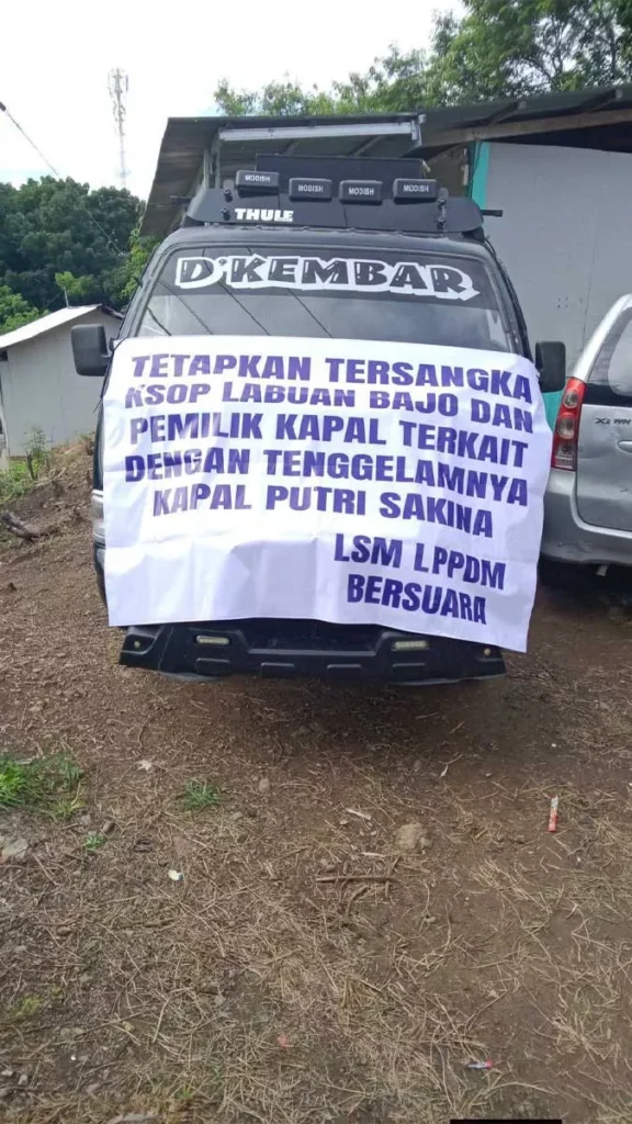 Safety for Sale? Labuan Bajo's Fury After a Fatal Shipwreck Exposes Tourism's Dark Undercurrent. 38 Photo of the Command Car for the action carried out in Labuan Bajo, January 8, 2026. The banner in front of the car reads: Name the Labuan Bajo KSOP and the Ship Owner as Suspects in Connection with the Sinking of the Putri Sakinah Ship