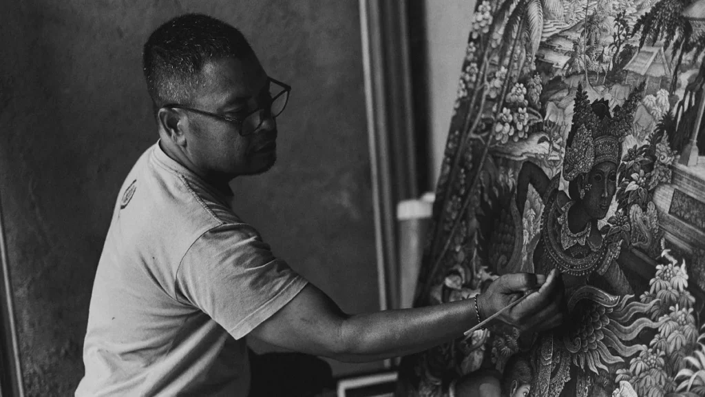 Daily photos of Balinese people, an artist is seen painting Balinese dance