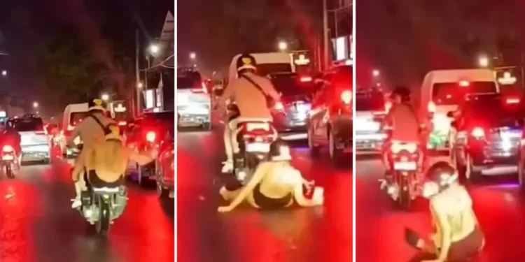 Video: A Very Bali Moment — Tourist Slips Off Scooter in Rainy Canggu, Laughs It Off 37 Video Screenshot of a Caucasian woman falling off her motorbike because she was busy playing with her cellphone in Canggu, Bali
