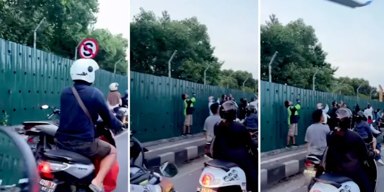 Screenshot of a video of Balinese residents stopping at the side of the road just to record a plane taking off (Hey Bali)