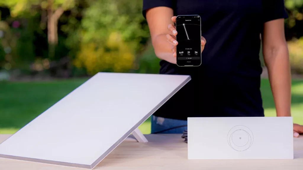 Illustration photo of Starlink device and person holding cellphone