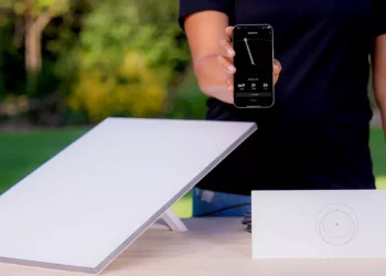 Illustration photo of Starlink device and person holding cellphone