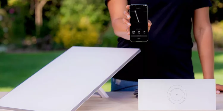 Illustration photo of Starlink device and person holding cellphone