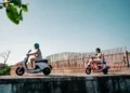 Photo of tourists in Bali riding electric motorbikes and walking to a tourist spot