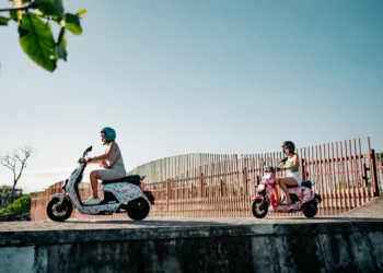 Beyond Villas: Why Electric Vehicles Could Be Bali’s Next Investment Boom—If You Get In Early 40 Photo of tourists in Bali riding electric motorbikes and walking to a tourist spot