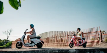 Photo of tourists in Bali riding electric motorbikes and walking to a tourist spot