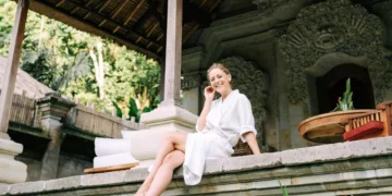 Illustration photo of a Caucasian woman relaxing on the front porch of her newly purchased house in Bali (Pexels)