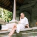 Illustration photo of a Caucasian woman relaxing on the front porch of her newly purchased house in Bali (Pexels)