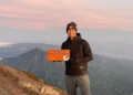 Photo of a European tourist taking a photo at the peak of Mount Agung, Bali (IST)
