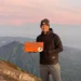 Photo of a European tourist taking a photo at the peak of Mount Agung, Bali (IST)