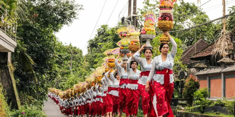 Most Visitors Think Galungan Is One Holiday. Bali's Ancient Texts Say There Are Three. 37 Balinese Hindu women carry colorful ceremonial offerings during a Galungan procession in a traditional village in Bali, Indonesia, celebrating the victory of good over evil.