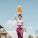 A river of devotion flows through a Balinese village as women carry elaborate gebogan offerings during Galungan, one of Bali's most sacred celebrations honoring the triumph of good over evil.