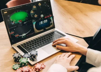 Illustration of someone playing online gambling on a laptop.