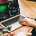 Illustration of someone playing online gambling on a laptop.