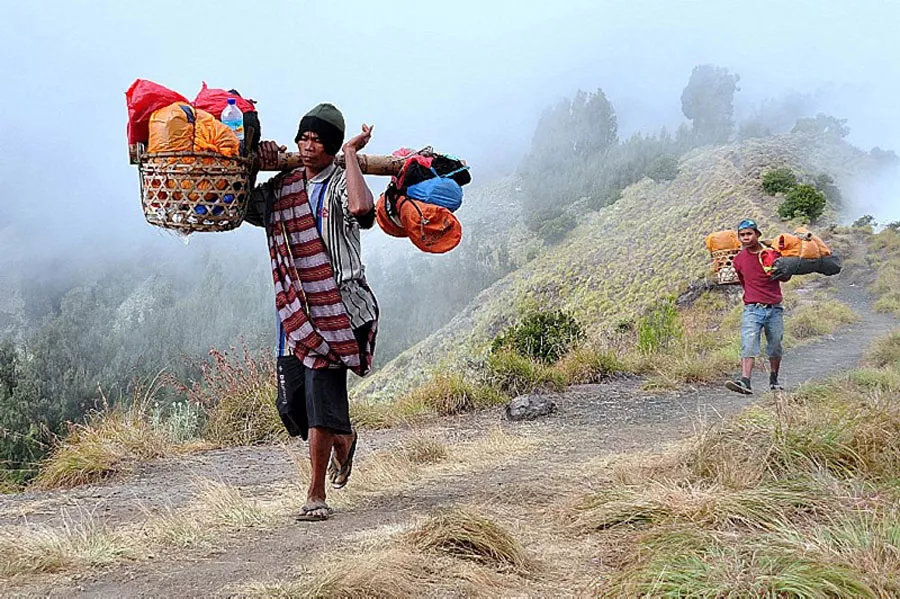 Mount Rinjani Is Raising the Bar: All Guides and Porters to Carry Official Access Cards Under New Safety Push 39 Photo of Porters helping to carry goods on Mount Rinjani