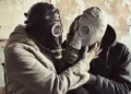 The Most Dangerous Lesson Schools Never Teach: How to Recognize Manipulation 50 Two people wearing gas masks embrace each other, symbolizing emotional manipulation, toxic relationships, and hidden psychological control.
