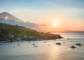 A view of the north coast of Bali at sunset—featuring the peak of Mount Agung, forested slopes, and the Java Sea—seen from a hilltop near Amed, Bali, Indonesia. (depositphotos.com/emcamposphoto)