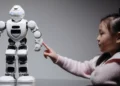 An illustrative photo of a young girl interested in learning about technology and AI through robotics.
