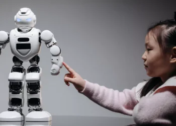 An illustrative photo of a young girl interested in learning about technology and AI through robotics.