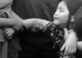 Photo: A first-grade student—the child of an alleged chicken thief who was killed by a mob—weeps over his father's body at the funeral home. (Instagram screenshot)