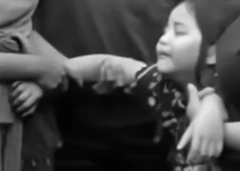 Photo: A first-grade student—the child of an alleged chicken thief who was killed by a mob—weeps over his father's body at the funeral home. (Instagram screenshot)