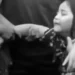 Photo: A first-grade student—the child of an alleged chicken thief who was killed by a mob—weeps over his father's body at the funeral home. (Instagram screenshot)