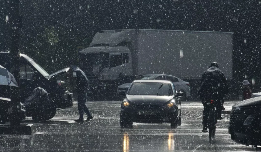 Heavy rain falls over a roadway during severe weather as BMKG issues a heavy rain and strong wind warning across East Nusa Tenggara (NTT), Indonesia.