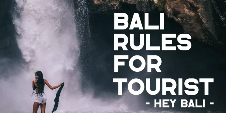 Bali rules for tourists guide featuring a visitor enjoying a waterfall while practicing responsible travel and respecting local customs.