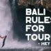 Bali rules for tourists guide featuring a visitor enjoying a waterfall while practicing responsible travel and respecting local customs.