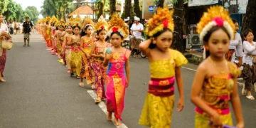 Young Balinese girls take part in a traditional cultural procession, reflecting the next generation preserving Bali's cultural heritage and identity.