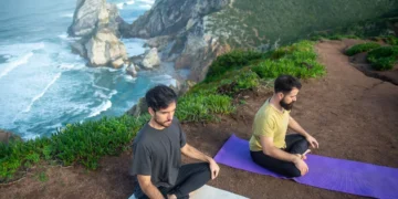 People practicing mindfulness meditation outdoors to calm a racing mind naturally