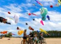 Thousands of Kites, Some Over 25 Meters Long, Take Over Sanur's Skies for Bali's Rare Angon Festival 49 Visitors watch giant international kites during the Rare Angon Festival at Mertasari Beach in Sanur, Bali.