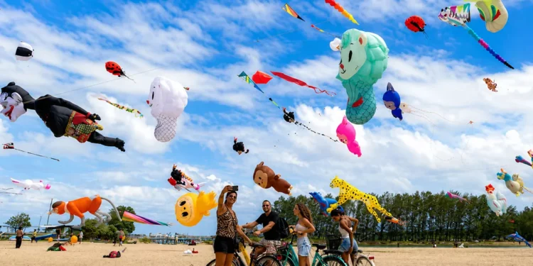 Visitors watch giant international kites during the Rare Angon Festival at Mertasari Beach in Sanur, Bali.