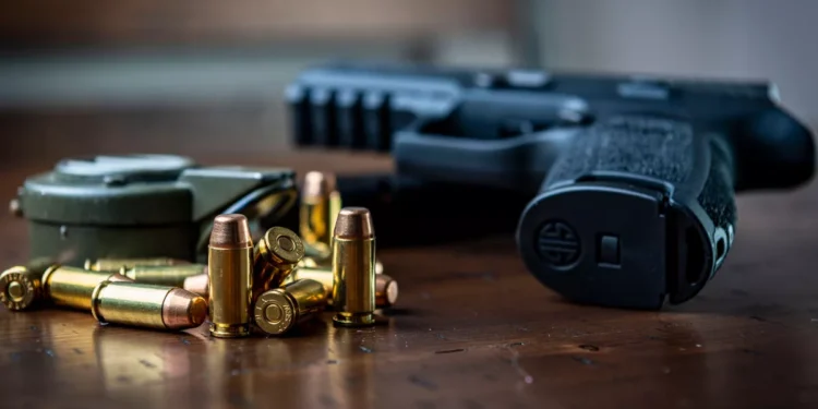 Illustration of a handgun and bullets