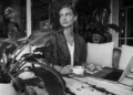 Digital nomad working from a Bali café with coffee, reflecting the connection between coffee culture, productivity, and personality.