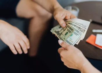 Illustrative photo of someone lending money to another party.