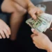 Illustrative photo of someone lending money to another party.
