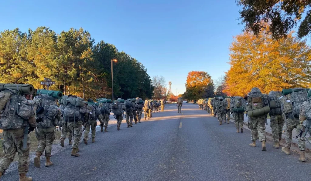 Ruck Walking: The Simple Twist That's Turning Bali's Favorite Exercise Into a Full-Body Workout 38 Military personnel performing ruck walking with heavy backpacks, the training method that inspired today's popular rucking fitness trend.