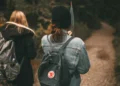 Ruck walking with weighted backpacks on a forest trail, illustrating the growing fitness trend that could become popular in Bali.