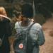 Ruck walking with weighted backpacks on a forest trail, illustrating the growing fitness trend that could become popular in Bali.