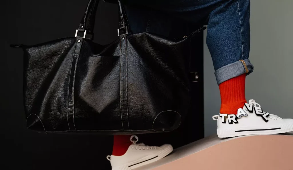 What Shoes Should You Wear in Bali? Sandals, Sneakers or Hiking Boots? 8 Travel bag and casual sneakers packed for a Bali vacation, showing practical travel shoes for island adventures.