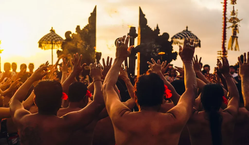Slow Tourism in Bali: Why More Travelers Are Skipping the Checklist and Staying Put 39 Slow Tourism in Bali visitors staying to experience the full Kecak dance performance at Uluwatu Temple during sunset.