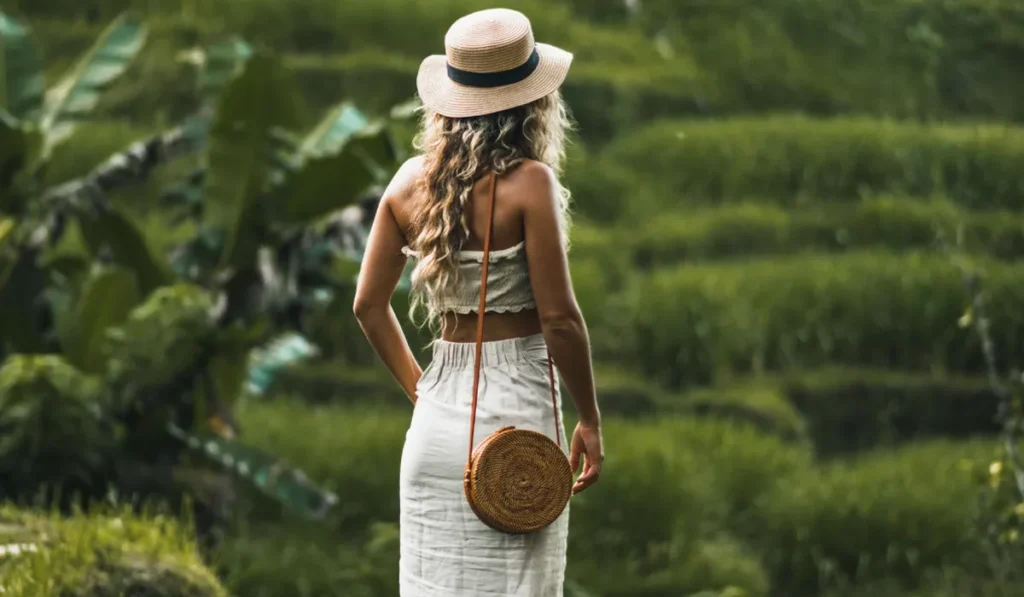 Slow Tourism in Bali walking through lush rice fields and supporting local communities by exploring at a slower pace.