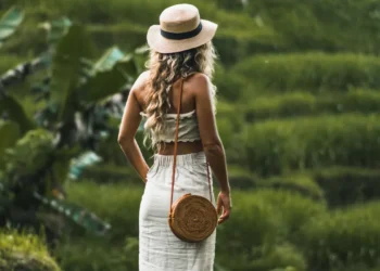 Slow Tourism in Bali walking through lush rice fields and supporting local communities by exploring at a slower pace.