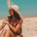 Can You Get Sunburned on a Cloudy Day? Doctors Say Yes, and Bali's Overcast Days Are No Exception 47 Can You Get Sunburned on a Cloudy Day? A photo of a female tourist sunbathing on a beach in Bali, wearing a straw hat.